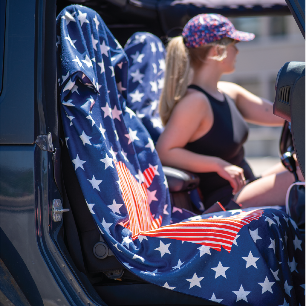Towel on car seat showing united states map against repeating pattern of stars, red white and blue colors