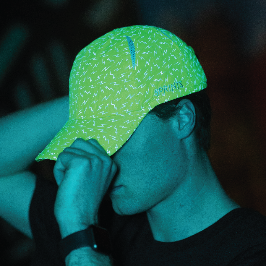 Man wearing neon green hat with lightning bolts