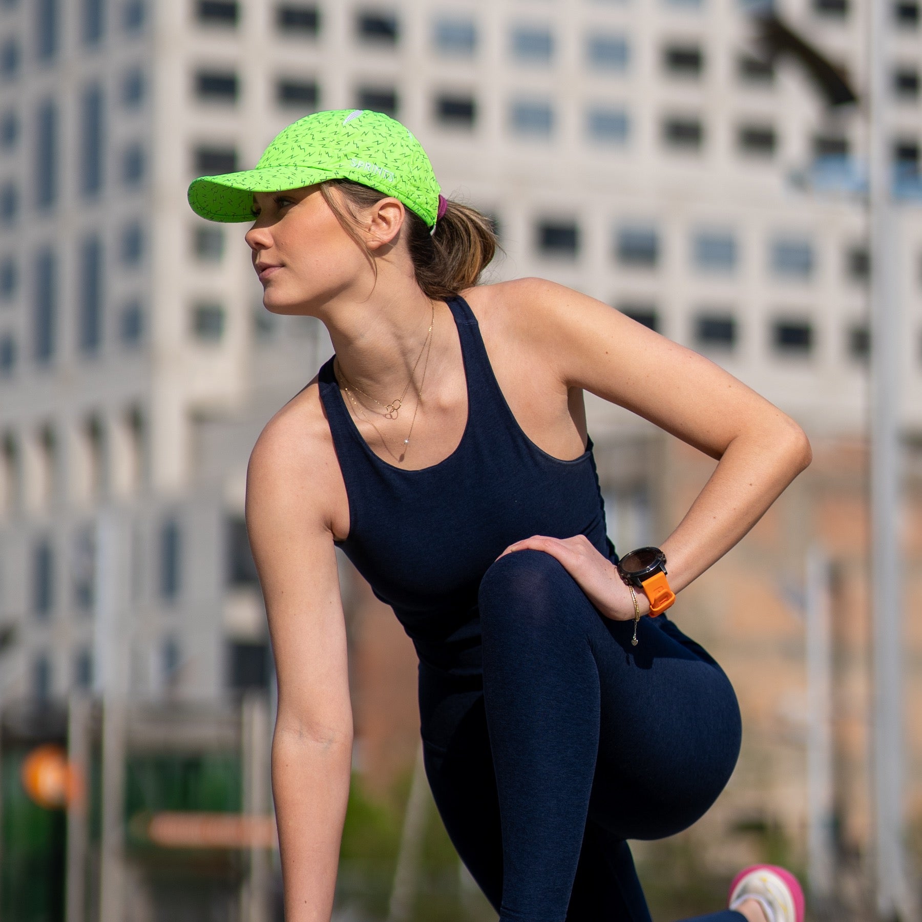 woman wearing neon green hat with lightning bolts