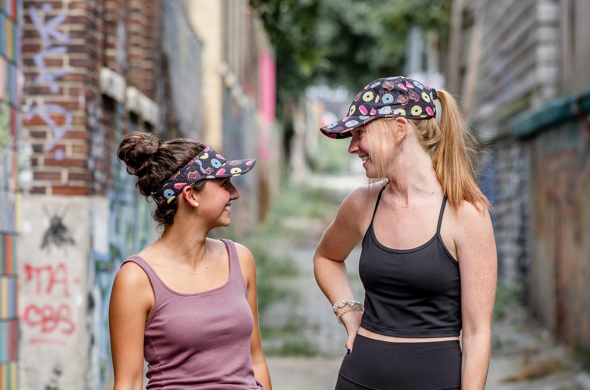 Two people wearing donut hats