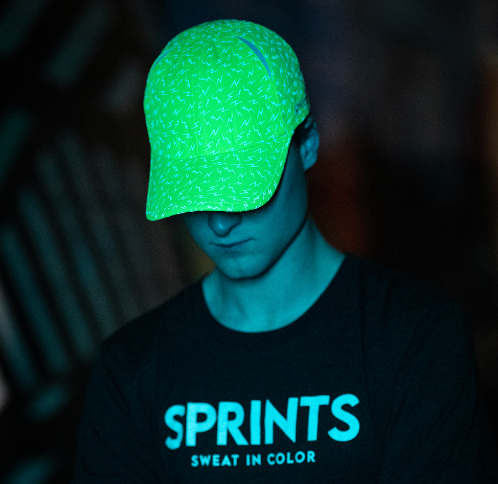 A man wearing a neon yellow reflective hat. 