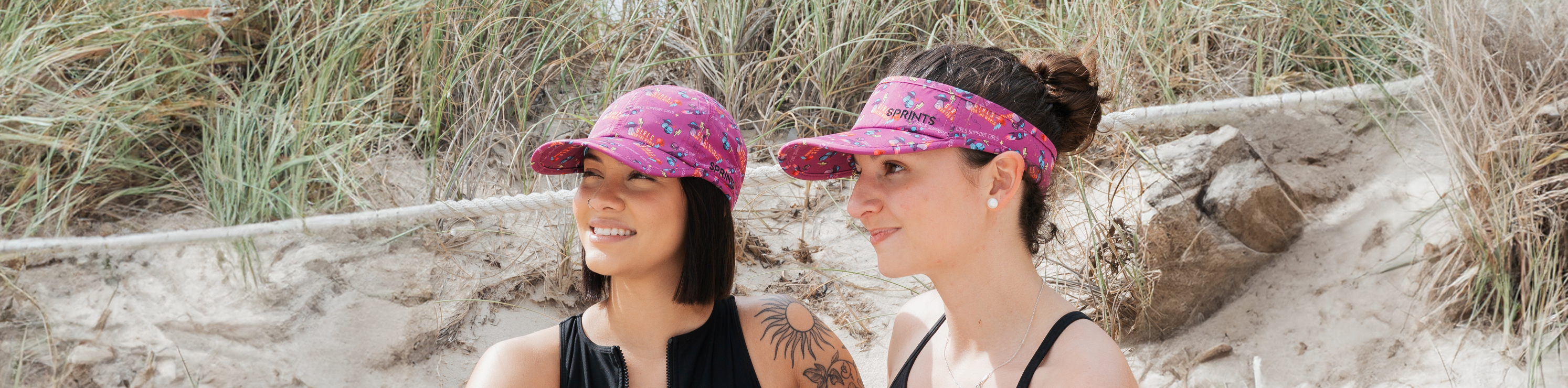 two girls in hats on the beach