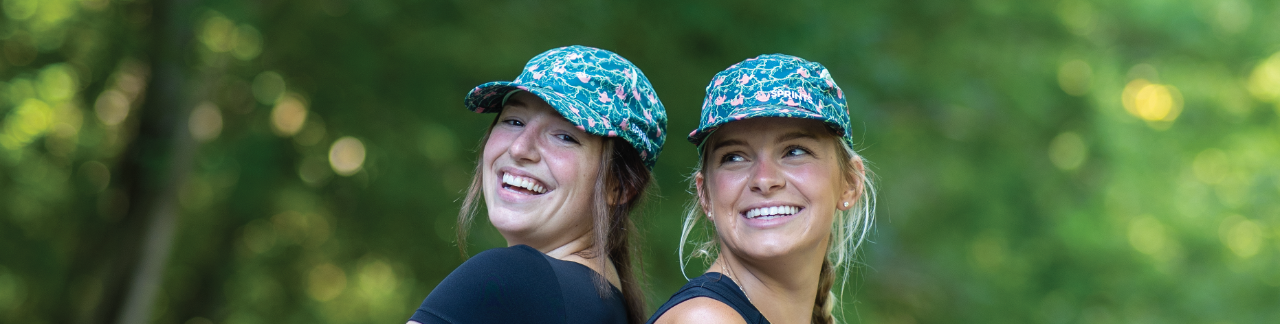 Two girls in sloth hats smiling