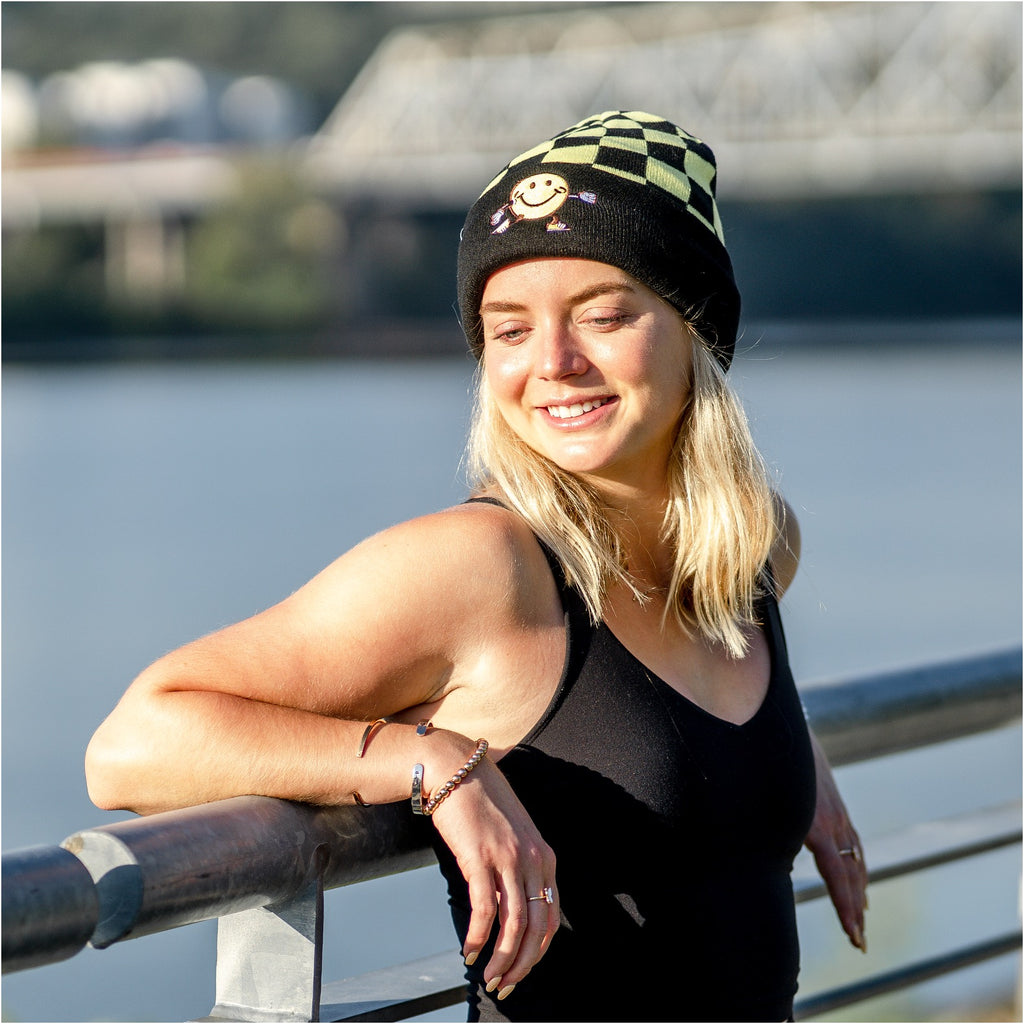 woman wearing winter beanie with smiley embroidery 